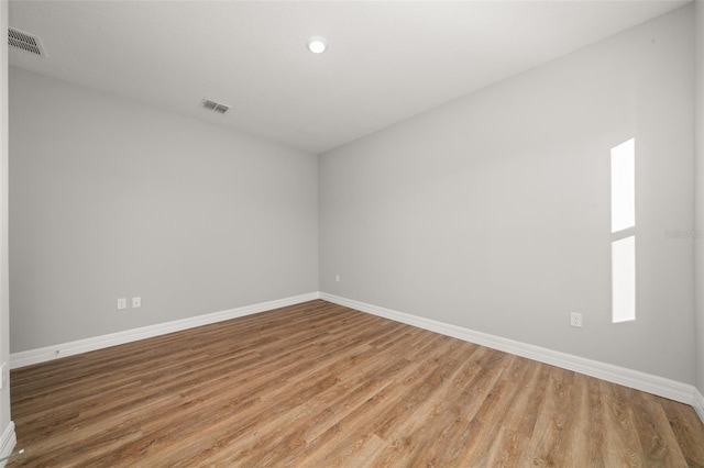 unfurnished room with hardwood / wood-style flooring