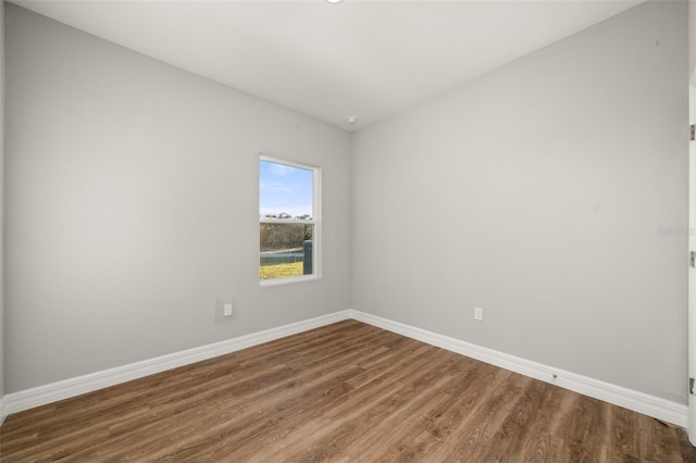 spare room with wood-type flooring