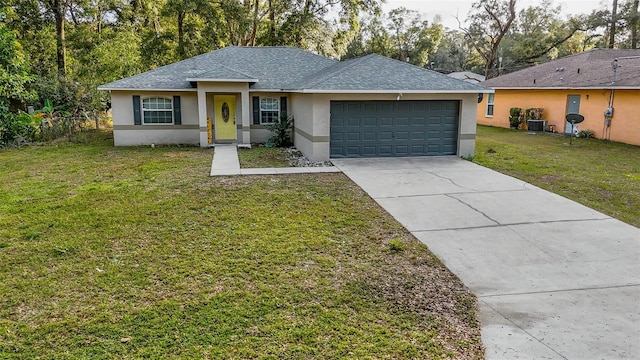 ranch-style home featuring cooling unit, a garage, and a front lawn