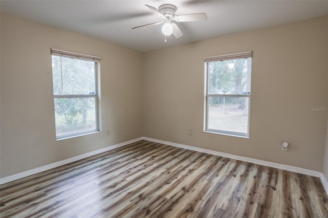 unfurnished room with ceiling fan, a healthy amount of sunlight, and light hardwood / wood-style flooring