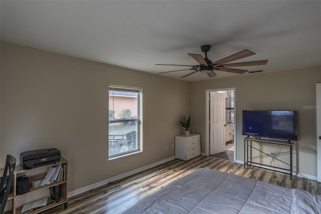 bedroom with hardwood / wood-style flooring and ceiling fan