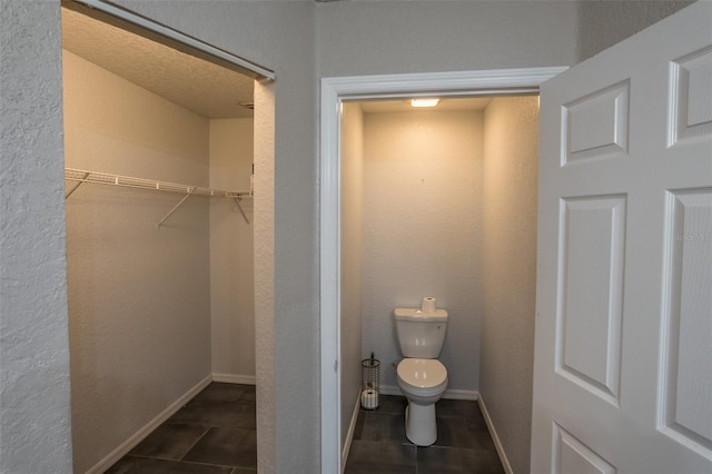 bathroom with toilet and tile patterned floors