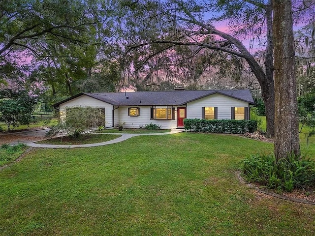 ranch-style home with a yard