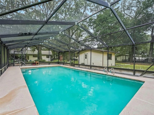 view of swimming pool with glass enclosure