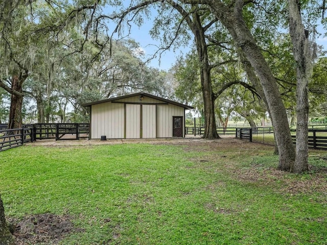 view of yard featuring a rural view and an outdoor structure