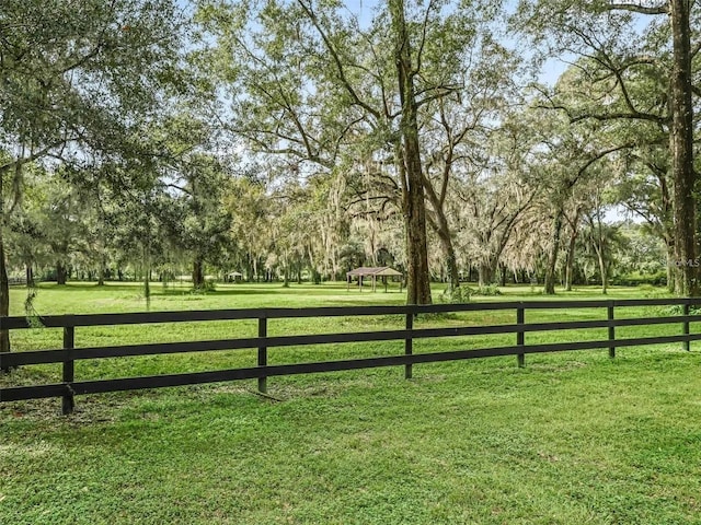 view of gate featuring a gazebo and a yard