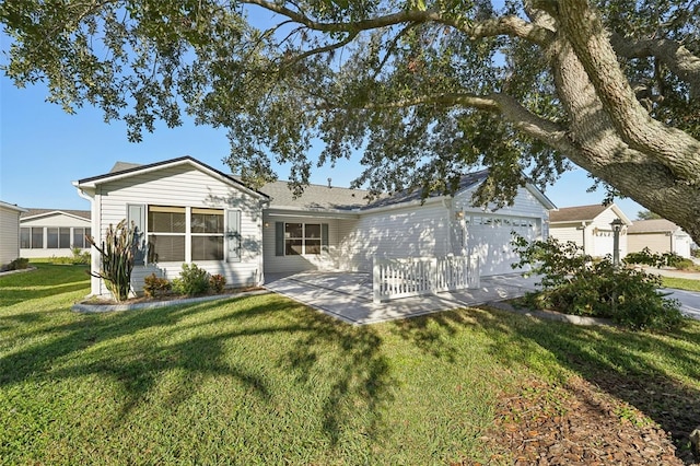 view of front of home with a garage and a front lawn