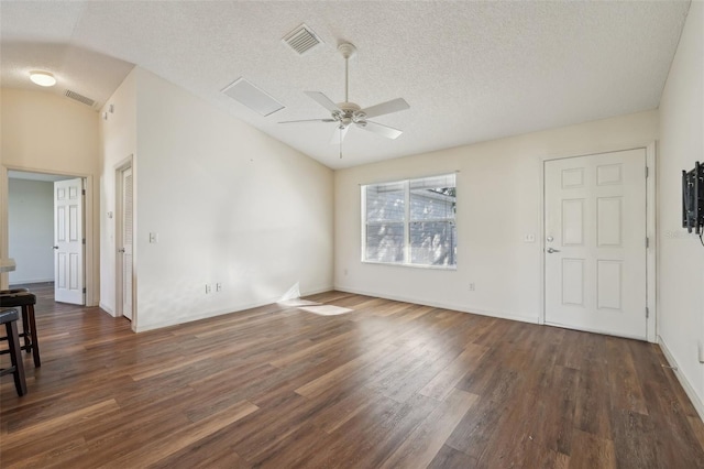 unfurnished room featuring ceiling fan, lofted ceiling, a textured ceiling, and dark hardwood / wood-style flooring