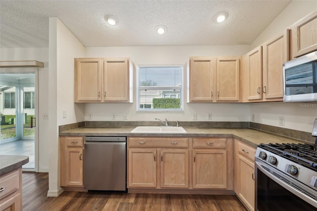 kitchen with stainless steel appliances, sink, and light brown cabinets