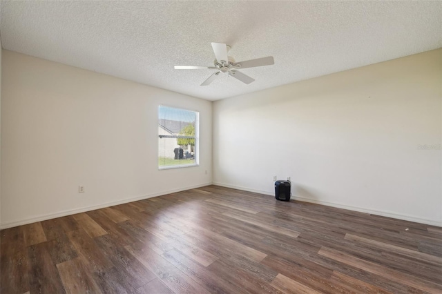 empty room with dark hardwood / wood-style flooring, ceiling fan, and a textured ceiling