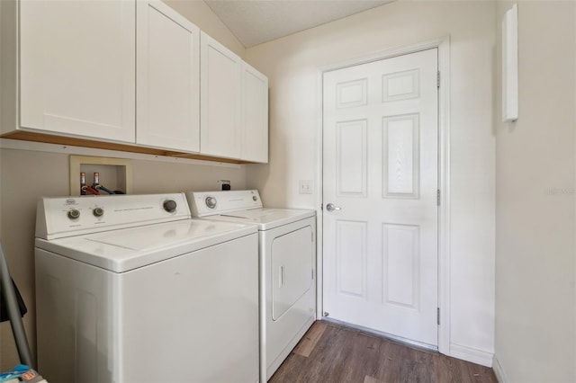 washroom featuring cabinets, dark hardwood / wood-style flooring, and washer and dryer