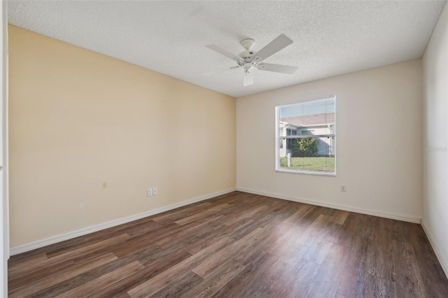 spare room with ceiling fan, dark hardwood / wood-style floors, and a textured ceiling