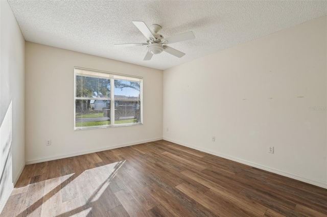 spare room featuring ceiling fan, a textured ceiling, and dark hardwood / wood-style flooring