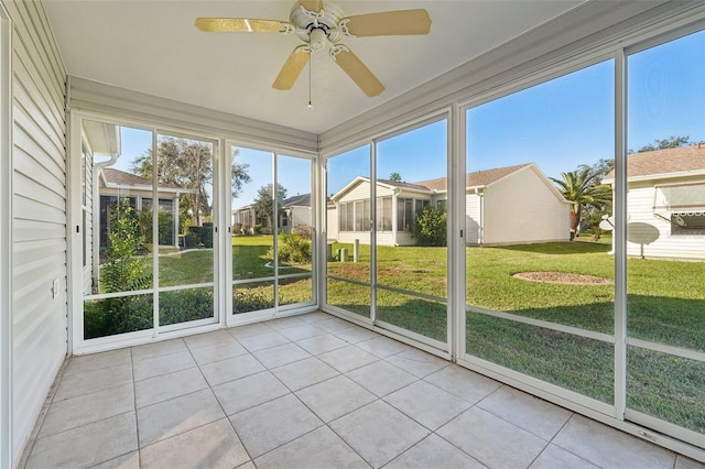 unfurnished sunroom with ceiling fan