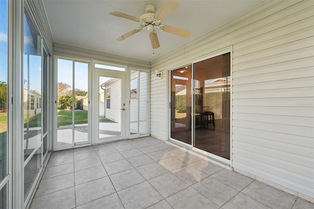 unfurnished sunroom with ceiling fan and a healthy amount of sunlight