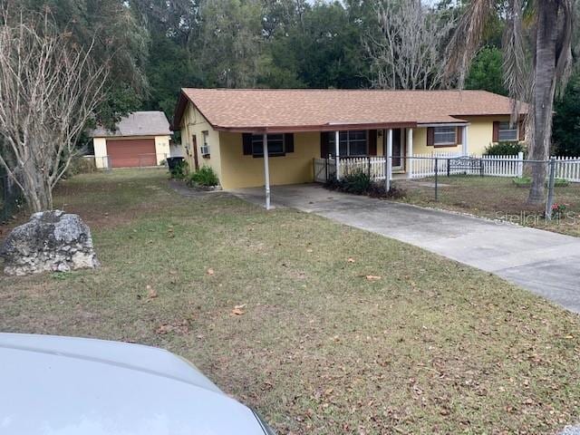 1855 NE 23rd St, Ocala, FL 34470 - single story home with a porch, a front yard, and a carport