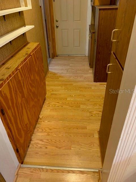 corridor with light wood-type flooring