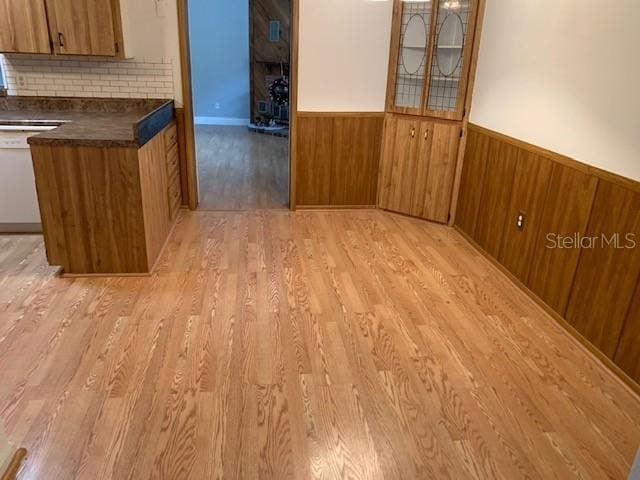 unfurnished dining area featuring light wood-type flooring