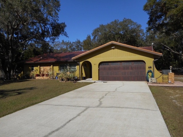 ranch-style home featuring a front yard and a garage