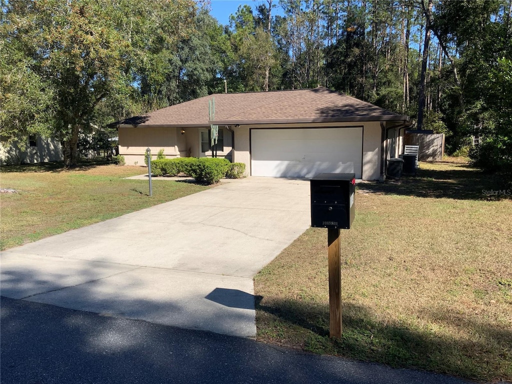 10149 N Darwin Way, Citrus Springs, FL 34434 - ranch-style house featuring a front lawn and a garage