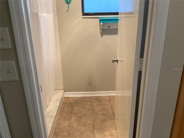 bathroom featuring tile patterned floors and curtained shower