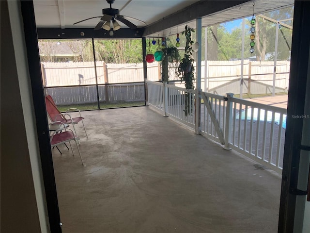 unfurnished sunroom with ceiling fan and a healthy amount of sunlight