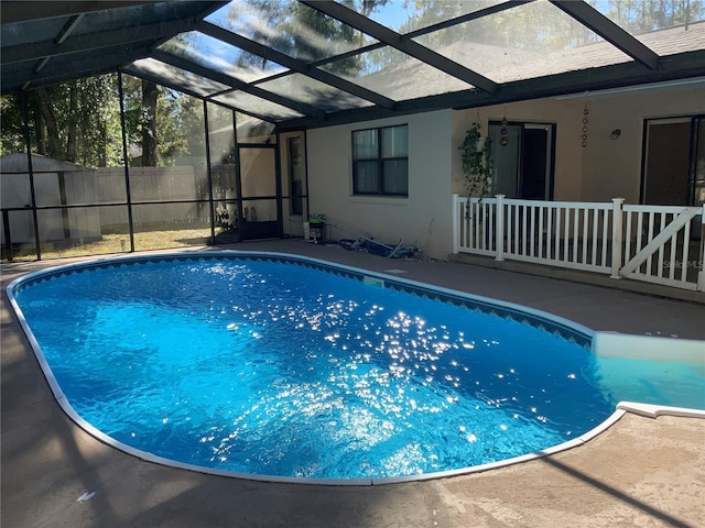 view of swimming pool featuring a lanai and a patio