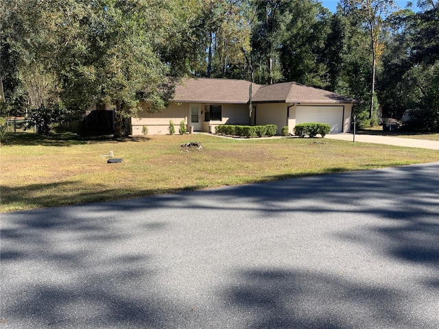 view of front of property featuring a garage and a front lawn