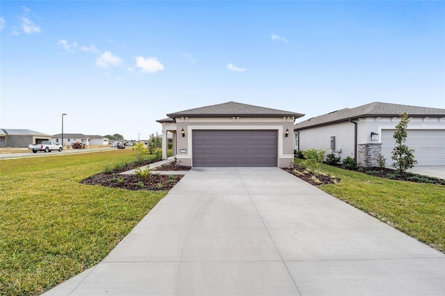 view of front facade with a garage and a front lawn