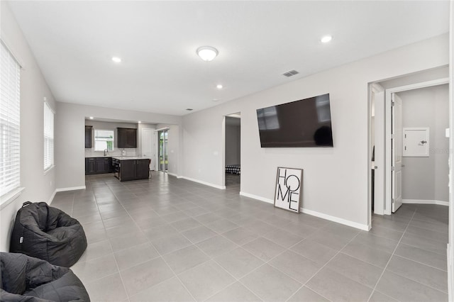 tiled living room featuring sink