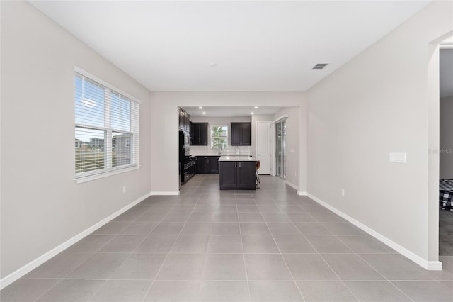 unfurnished living room featuring light tile patterned floors