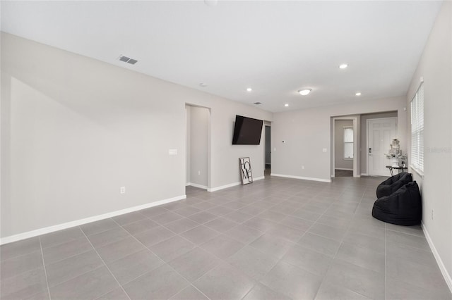 unfurnished living room with light tile patterned floors