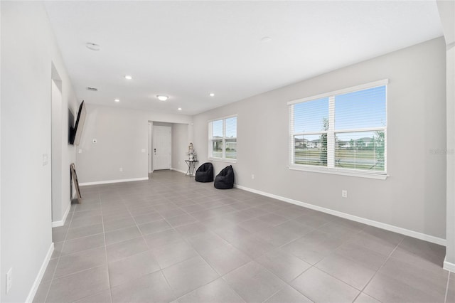 exercise room with light tile patterned floors