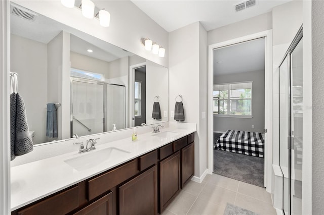 bathroom featuring tile patterned flooring, vanity, and an enclosed shower