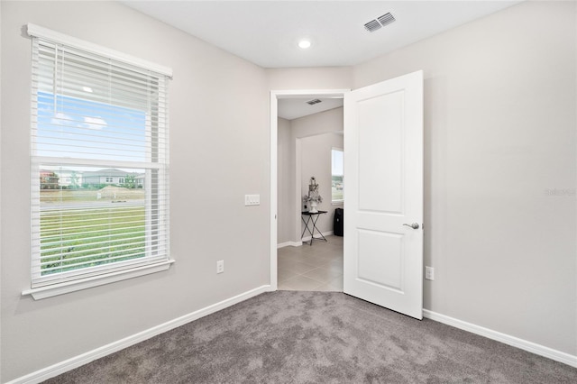 unfurnished bedroom featuring light colored carpet