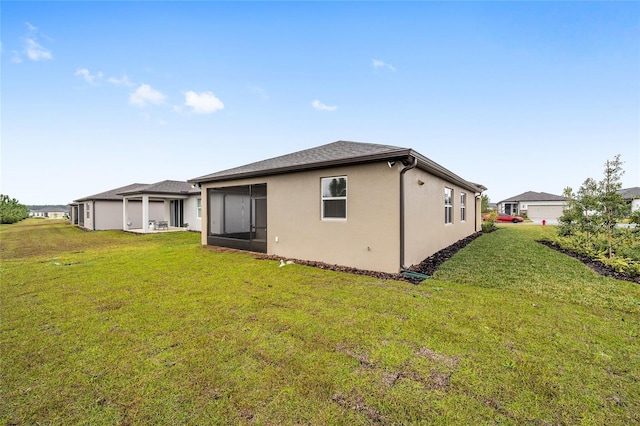 rear view of property with a yard