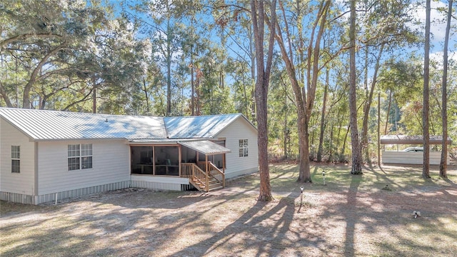 back of house featuring a sunroom