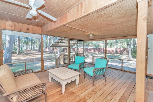 sunroom with ceiling fan and wood ceiling