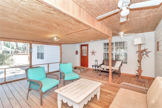 sunroom with ceiling fan and wood ceiling