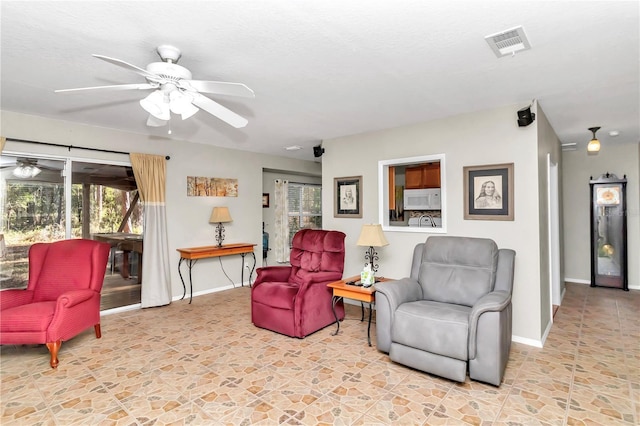 sitting room featuring ceiling fan