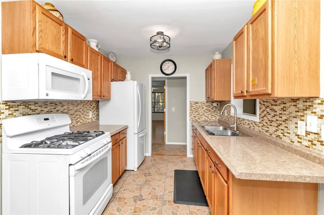 kitchen with backsplash, sink, and white appliances