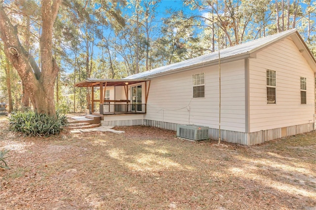 view of property exterior with central AC and covered porch