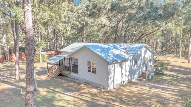 view of side of property featuring a sunroom