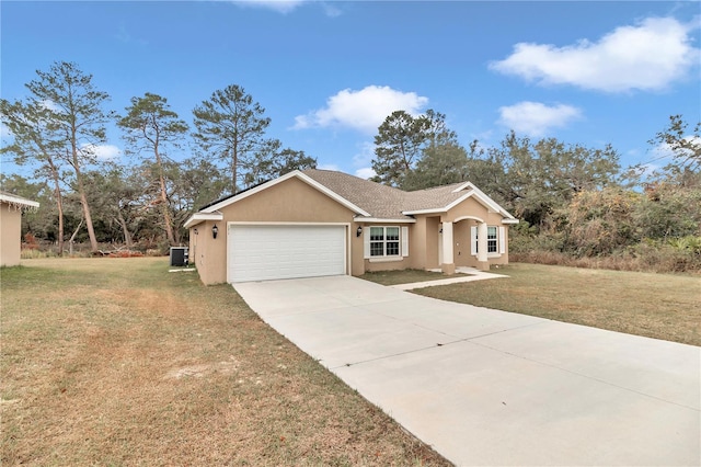 single story home with a front lawn, central AC unit, and a garage