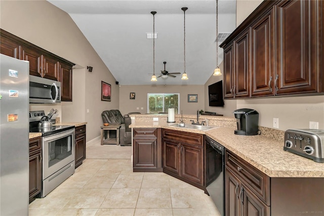 kitchen featuring sink, vaulted ceiling, ceiling fan, decorative light fixtures, and stainless steel appliances