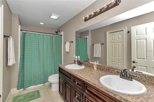 bathroom featuring tile patterned flooring, vanity, toilet, and walk in shower