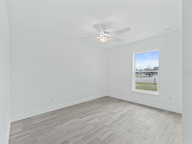 spare room with ceiling fan and light hardwood / wood-style flooring