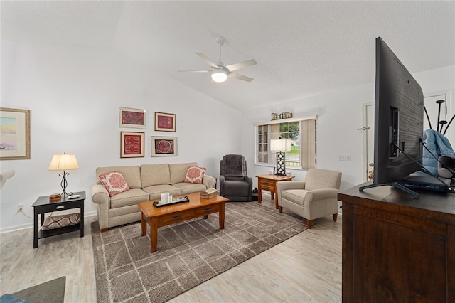 living room featuring hardwood / wood-style flooring, ceiling fan, a textured ceiling, and vaulted ceiling