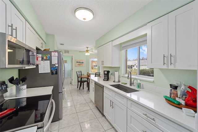 kitchen with sink, white cabinets, and stainless steel appliances