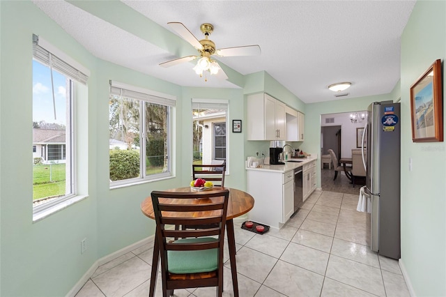 kitchen with white cabinetry, sink, ceiling fan, stainless steel appliances, and light tile patterned floors